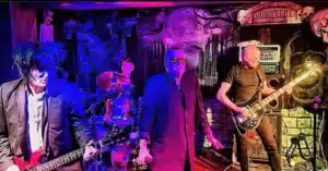 A group of musicians playing music in a dark room.