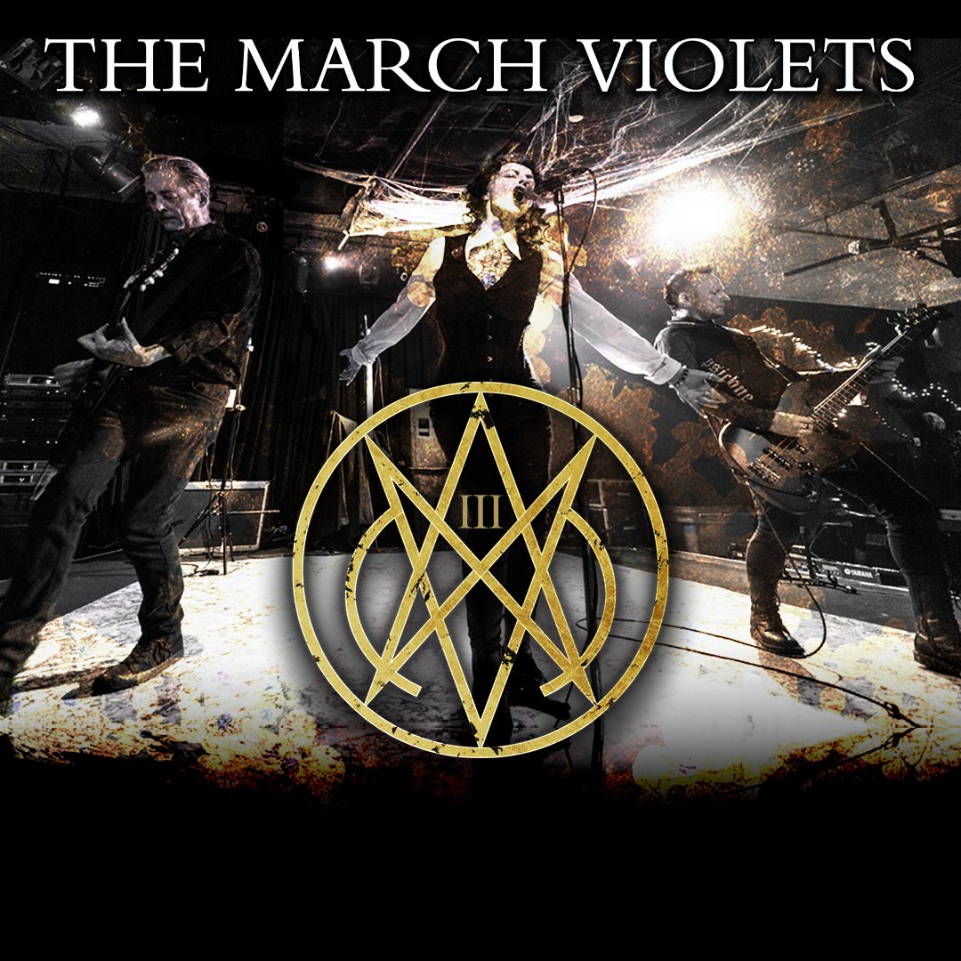 Three musicians perform on stage under bright lights, with THE MARCH VIOLETS text and a striking gold emblem prominently displayed at the centre.